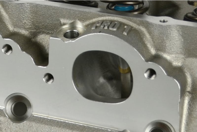 Exhaust ports on many performance aftermarket heads are raised in order to improve exhaust port flow. While the flange pattern is the same, it can be raised by as much as 0.500-inch which can affect fitment with an off-the-shelf chassis header.