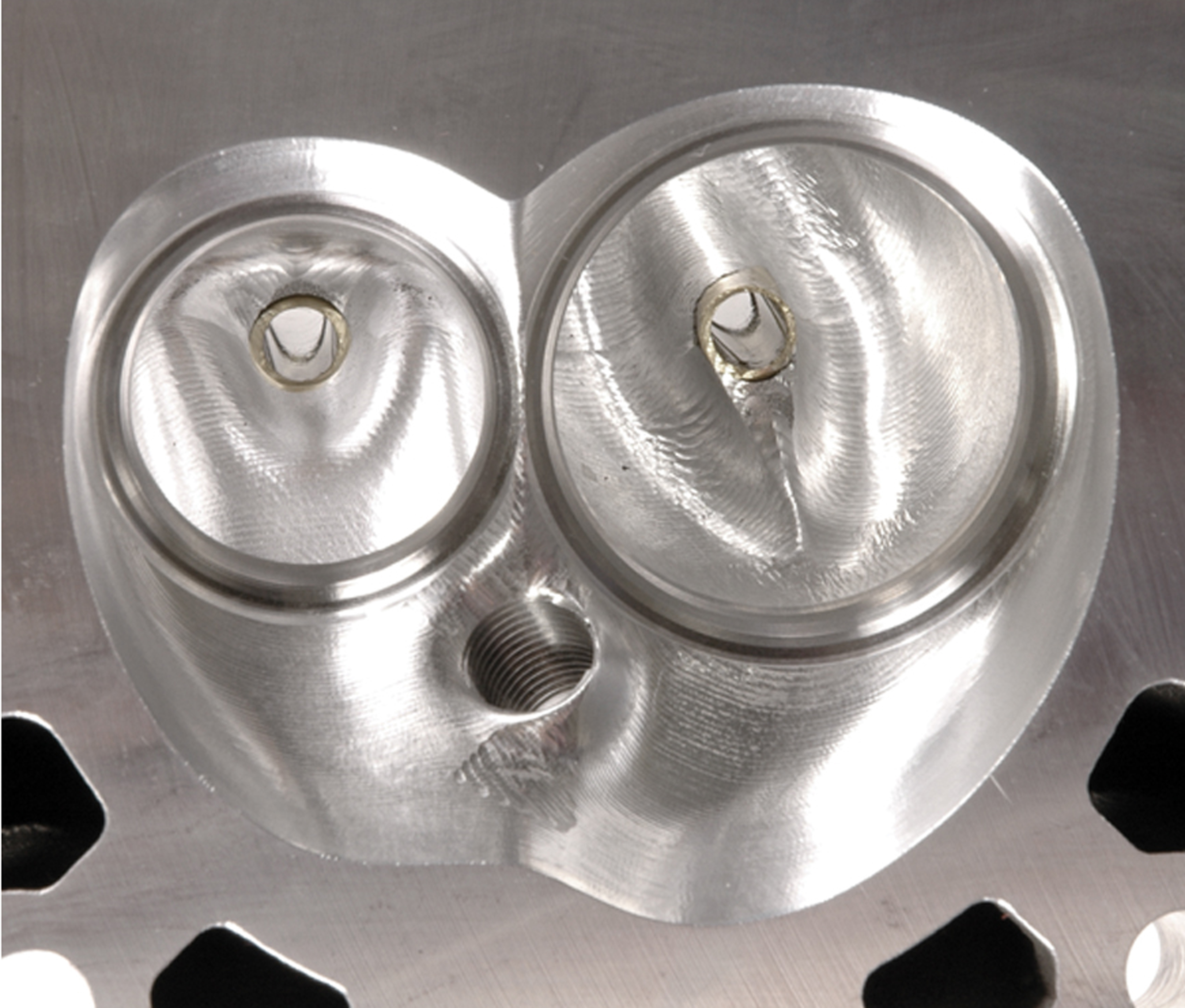 CNC porting massages the intake and exhaust ports to bring out the best in a cast port and is easily identified by the ridged, machined surface left by the cutting tool. This is a Dart 215cc Pro 1 LS cylinder head. The chamber has also been machined. 